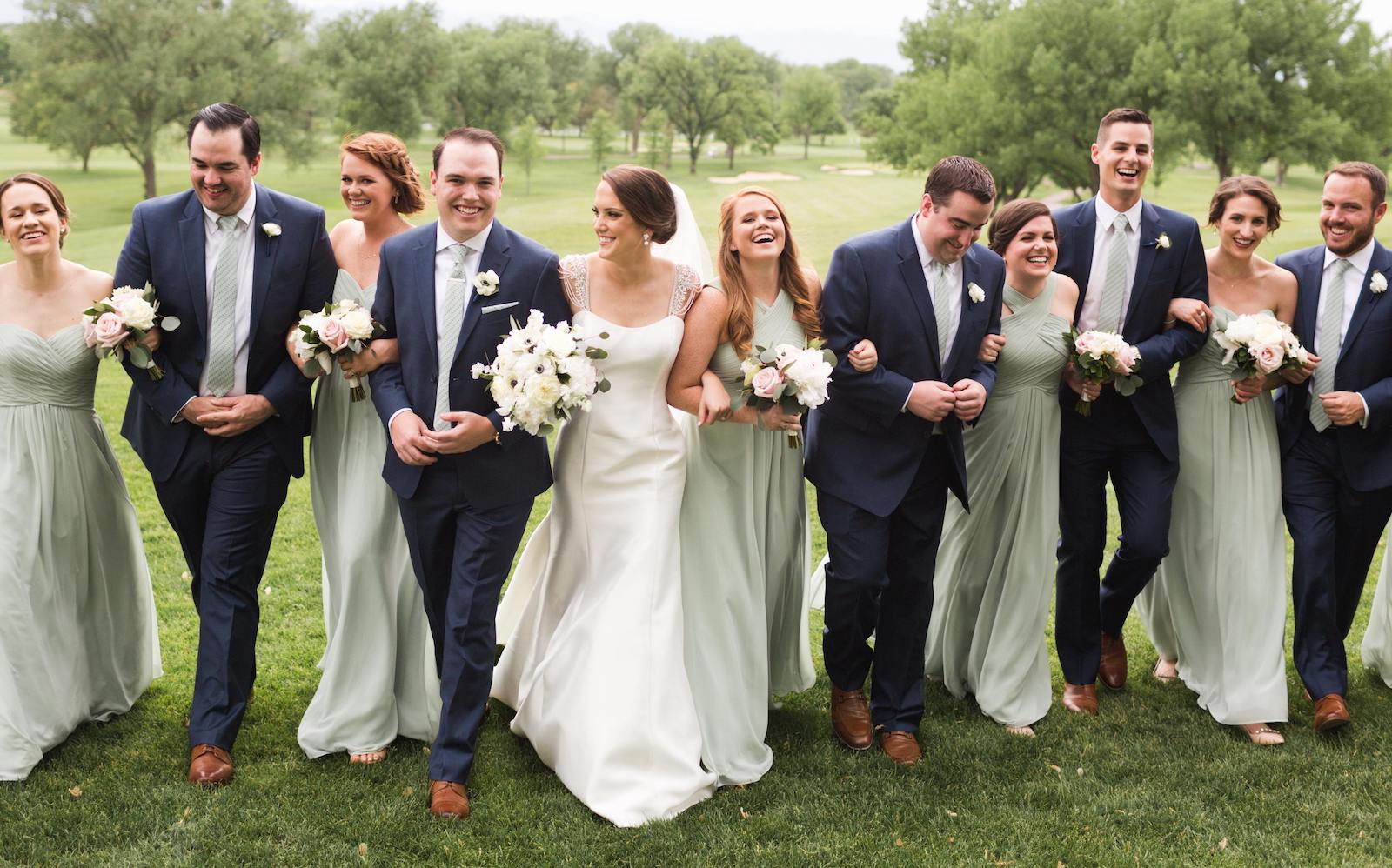 Wedding party with green bridesmaids dresses that match groom and groomsmen custom wedding ties